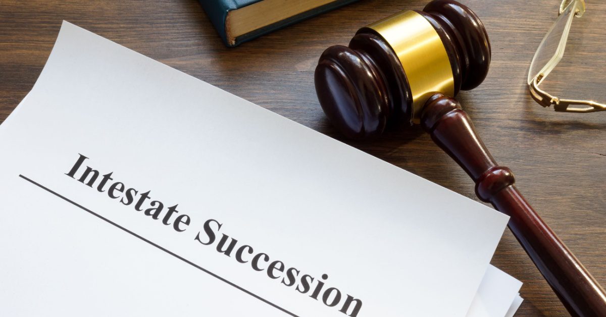 a gavel and paper with words written intestate succession